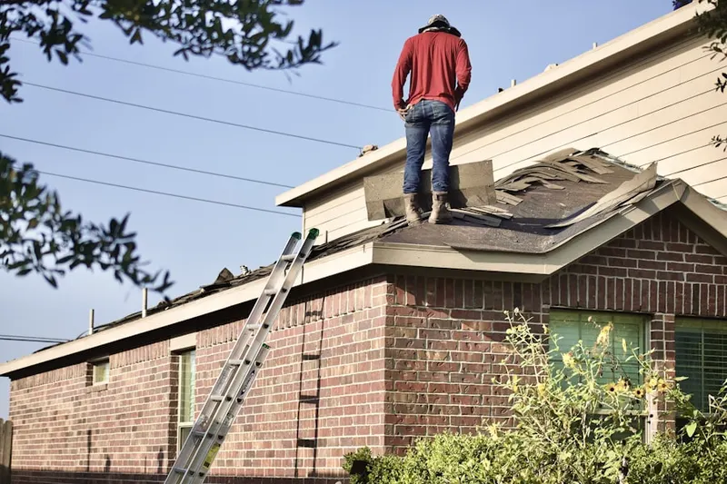 Professional roofer working on a residential roof in Brickell Business District